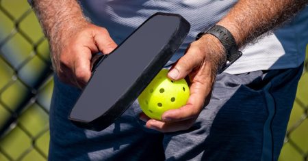 Here’s Why the Chainsaw Pickleball Serve Was Banned Man preparing to serve a pickleball with the chainsaw serve