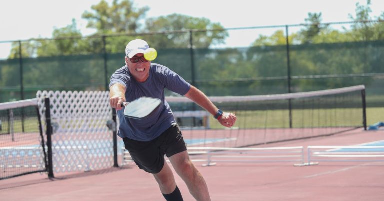 How To Hit A Pickleball Harder (Without Hurting Accuracy) Man returning a hard pickleball shot