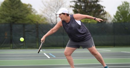 Where To Find The Best Pickleball Classes (Online & Offline) Pickleball player returning a serve