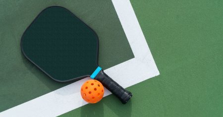 The Ultimate Pickleball Equipment List Pickleball equipment on a green court surface