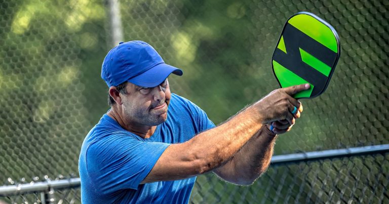 The 11 Best Pickleball Hitting Techniques Man hitting a two-handed pickleball backhand