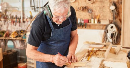 Man in a woodworking shop doing a DIY project