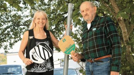 Pickleball Pioneer Jack Danielson Makes It Count! Kristi Boardman and Jack Danielson next to one of the original net poles - Image courtesy of Hannah Thompson of the Herald-Zeitung